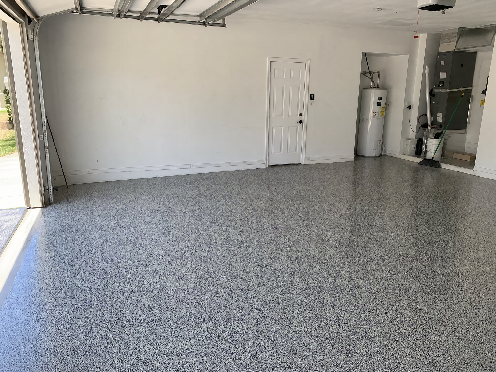 Completed polyaspartic garage floor coating showing professional quality workmanship in a American home